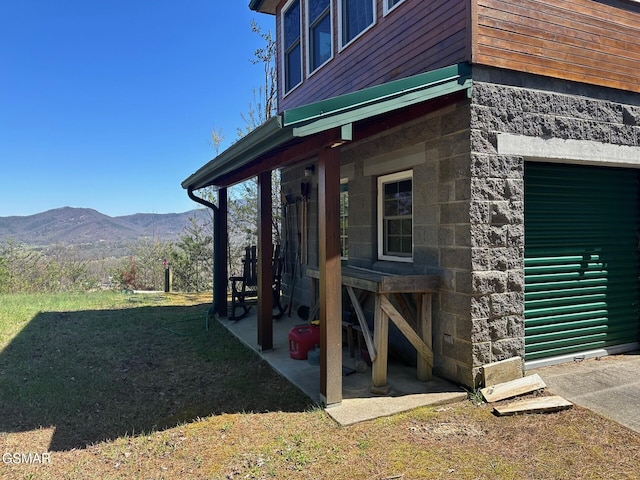 exterior space featuring a mountain view and a yard