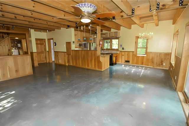 interior space with freestanding refrigerator, a wainscoted wall, and wood walls