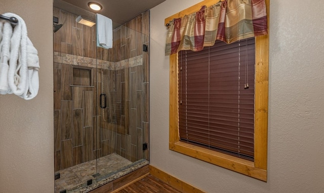 1106 Anastasia Way, Gatlinburg, TN 37738 - bathroom with a stall shower, a textured wall, and wood finished floors