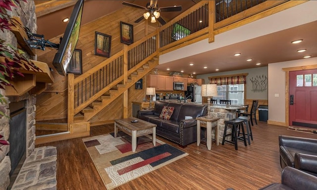 1106 Anastasia Way, Gatlinburg, TN 37738 - living room featuring wood finished floors, stairway, a stone fireplace, a ceiling fan, and recessed lighting