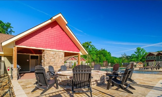 1106 Anastasia Way, Gatlinburg, TN 37738 - wooden deck with an outdoor fire pit, a patio area, and a swimming pool