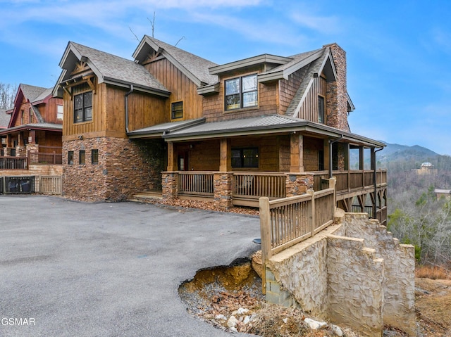 view of front of property featuring a mountain view and covered porch