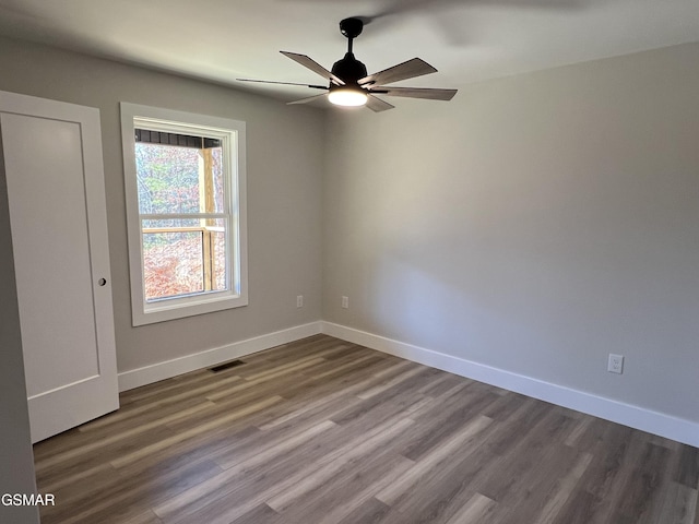 empty room featuring hardwood / wood-style flooring and ceiling fan