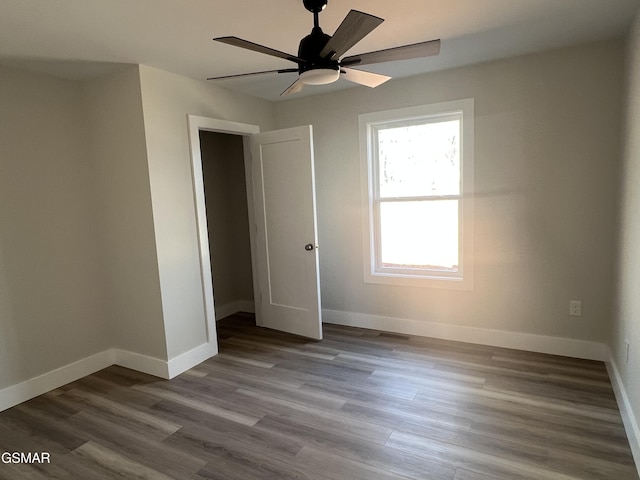 unfurnished bedroom with ceiling fan, a closet, and light hardwood / wood-style flooring