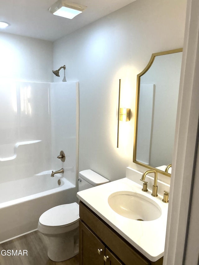 full bathroom with vanity, toilet, wood-type flooring, and tub / shower combination