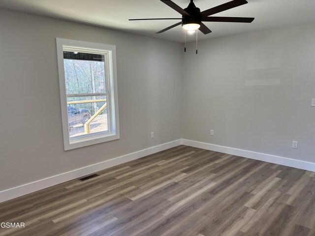 unfurnished room featuring ceiling fan and dark hardwood / wood-style floors