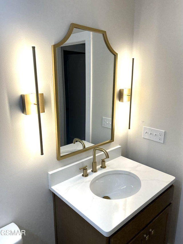 bathroom featuring vanity and toilet