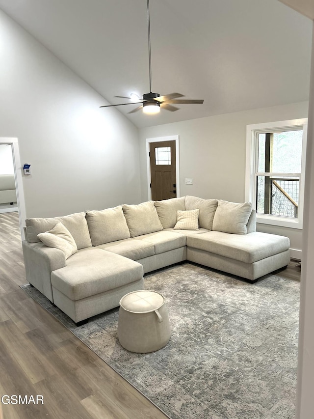 living room featuring hardwood / wood-style floors, ceiling fan, and lofted ceiling