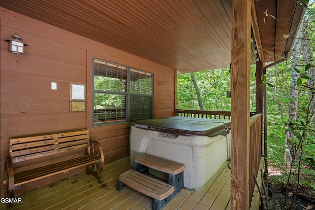 wooden deck featuring a hot tub