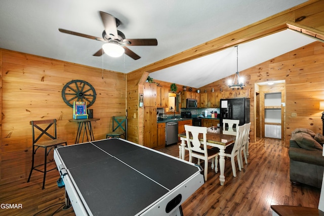 recreation room featuring ceiling fan, dark hardwood / wood-style floors, vaulted ceiling, and wood walls