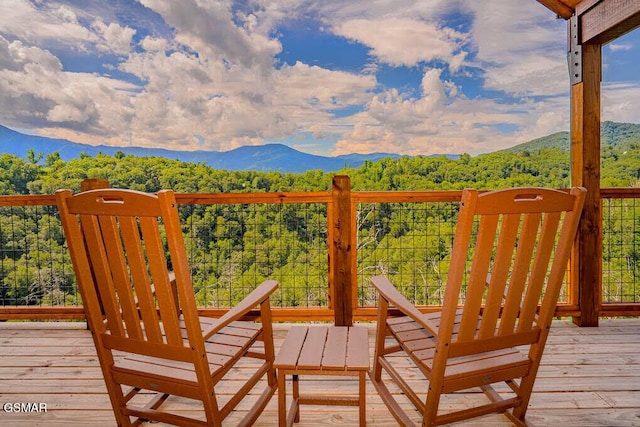 exterior space featuring a wooded view and a mountain view
