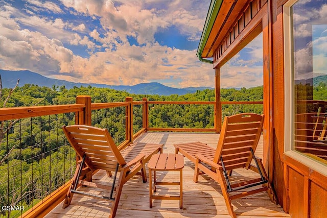 balcony with a wooded view and a mountain view