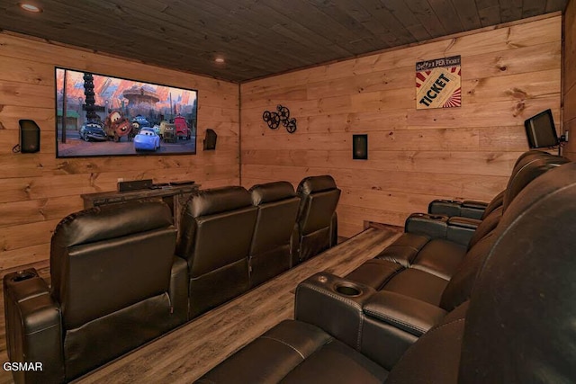 cinema room featuring wooden walls, wooden ceiling, and wood finished floors