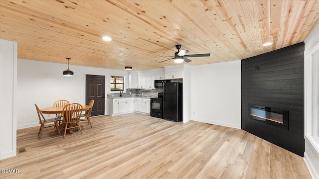 1204 Piney Mountain Rd, Newport, TN 37821 - kitchen with black appliances, wood ceiling, light countertops, white cabinetry, and light wood-type flooring