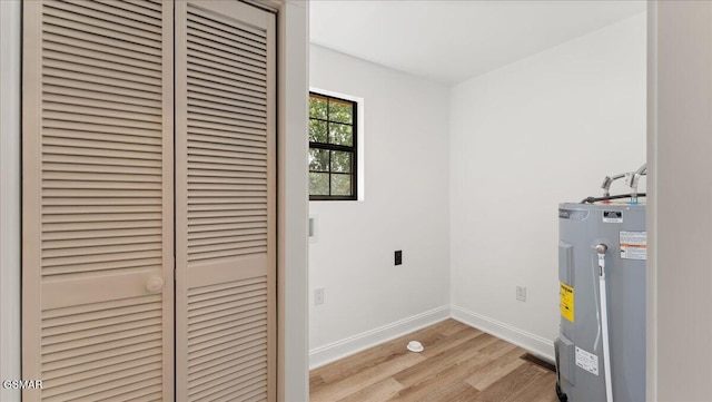 1204 Piney Mountain Rd, Newport, TN 37821 - laundry room featuring water heater and light wood-style floors
