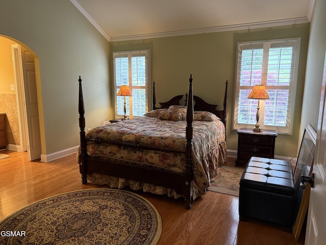 915 Fine Glen Dr, Sevierville, TN 37862 - bedroom featuring arched walkways, wood finished floors, crown molding, and baseboards