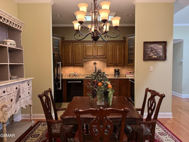915 Fine Glen Dr, Sevierville, TN 37862 - dining space with a chandelier, crown molding, light wood-type flooring, and baseboards