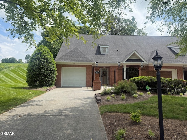 915 Fine Glen Dr, Sevierville, TN 37862 - view of front of house featuring brick siding, an attached garage, a shingled roof, concrete driveway, and a front lawn
