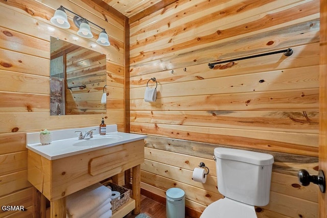 2864 Owens Ridge Way, Sevierville, TN 37876 - bathroom featuring wooden walls, toilet, vanity, and wood finished floors