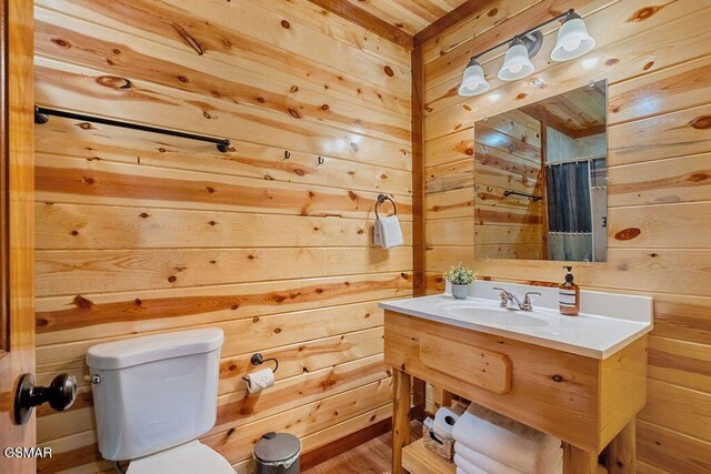 2864 Owens Ridge Way, Sevierville, TN 37876 - bathroom with wooden walls, toilet, vanity, and a shower with curtain