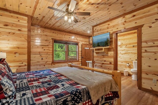 2864 Owens Ridge Way, Sevierville, TN 37876 - bedroom with wooden walls, light wood-type flooring, wood ceiling, and connected bathroom