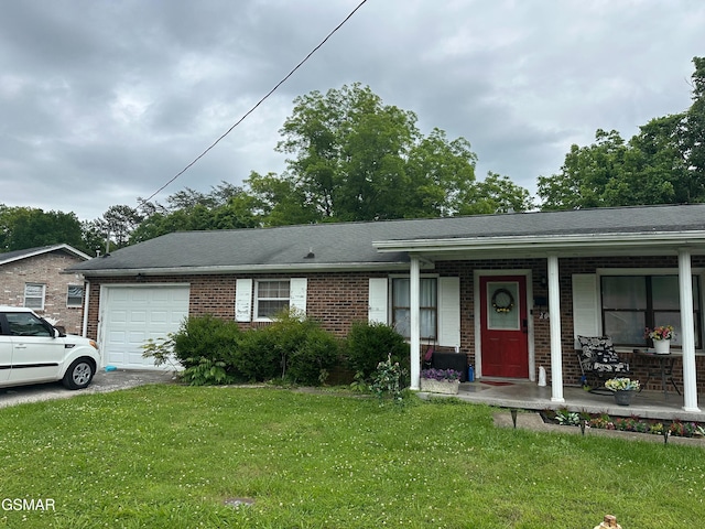 206 Bunker Ln, Oak Ridge, TN 37830 - ranch-style home featuring an attached garage, covered porch, brick siding, a front yard, and driveway