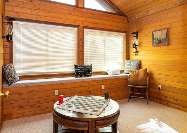 living area featuring carpet flooring, lofted ceiling, wood ceiling, and wooden walls