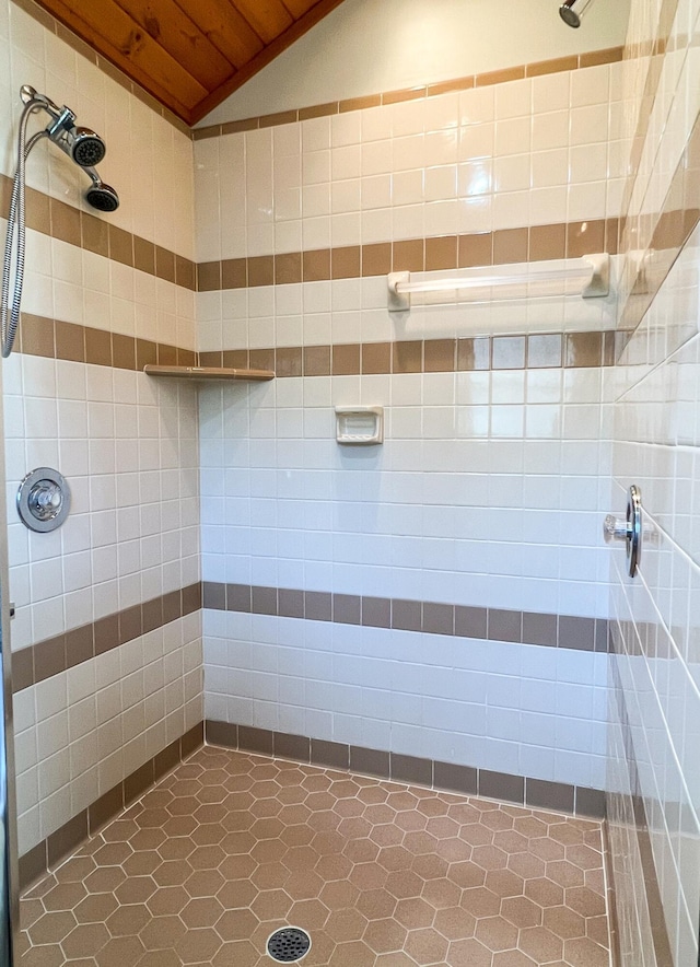 bathroom featuring a shower, tile patterned flooring, wood ceiling, and vaulted ceiling