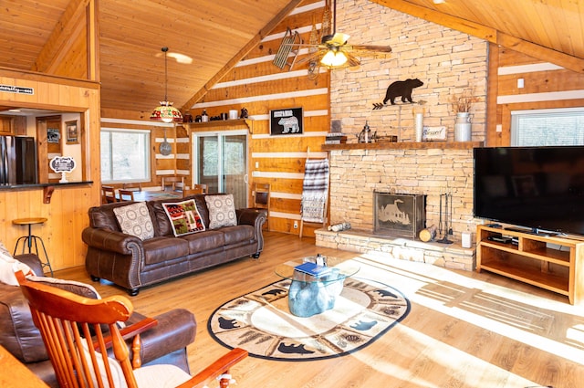 living room featuring wooden walls, a fireplace, high vaulted ceiling, and hardwood / wood-style flooring