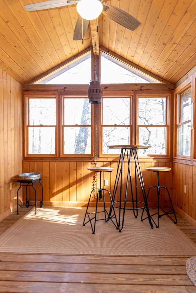 sunroom with ceiling fan, wood ceiling, and vaulted ceiling