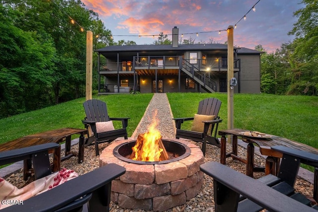 4822 White Pine Way, Sevierville, TN 37876 - back of property at dusk featuring a fire pit, a yard, stairway, and a chimney