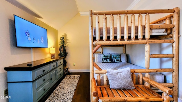 bedroom featuring dark wood-type flooring and vaulted ceiling