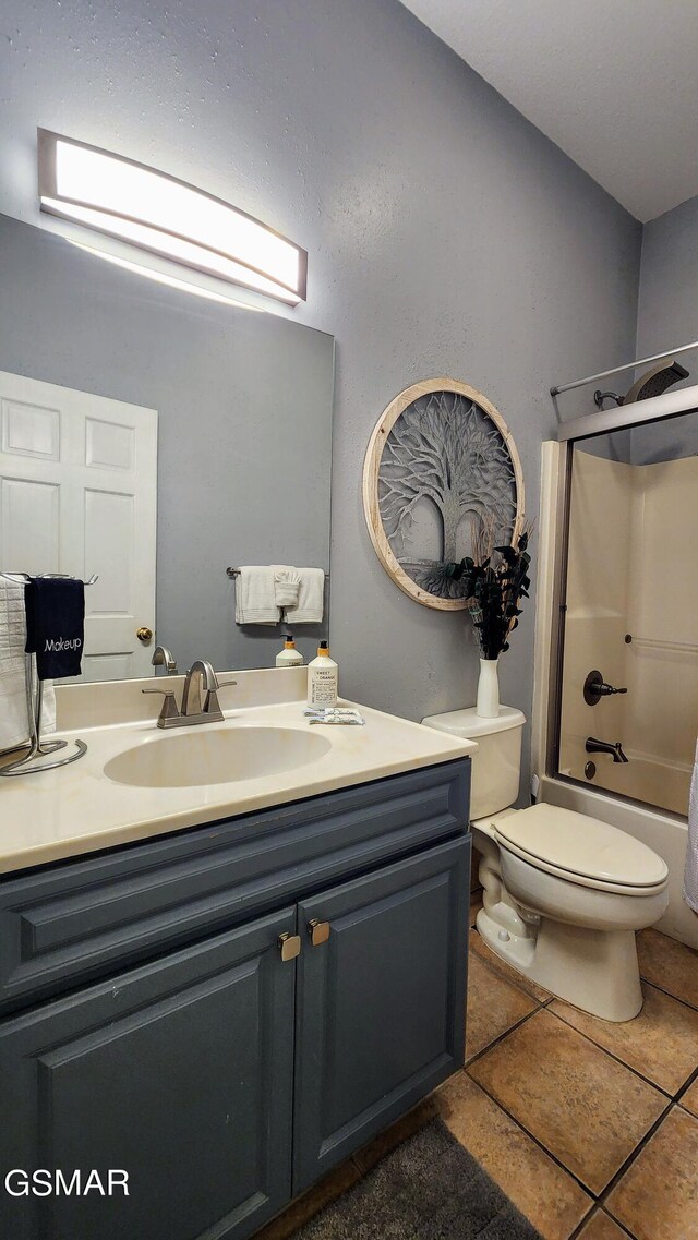 full bathroom with tile patterned flooring, shower / tub combination, vanity, and toilet