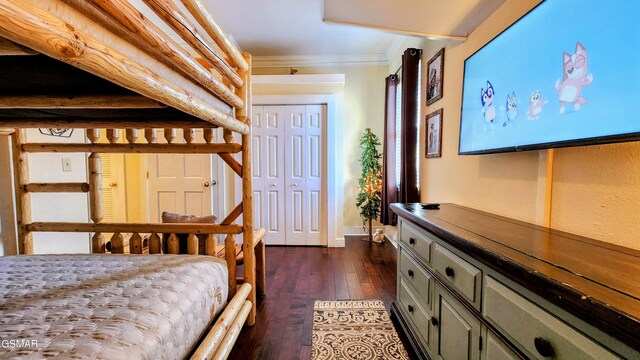 bedroom featuring dark wood-type flooring and ornamental molding