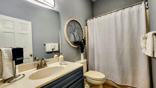 bathroom featuring vanity, toilet, and curtained shower