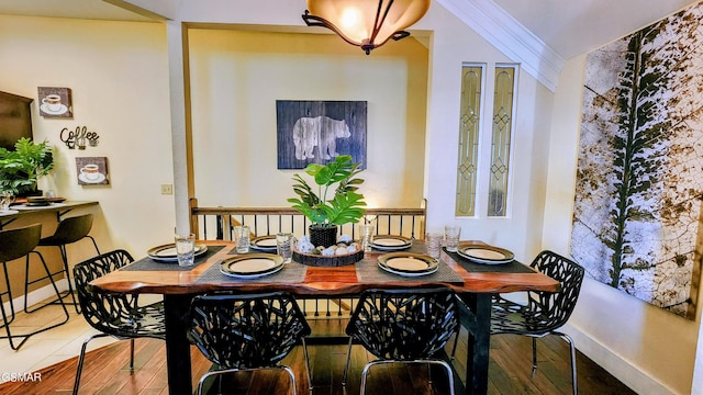 dining area featuring hardwood / wood-style flooring and ornamental molding