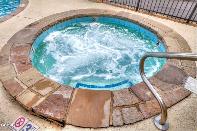 view of swimming pool with a community hot tub