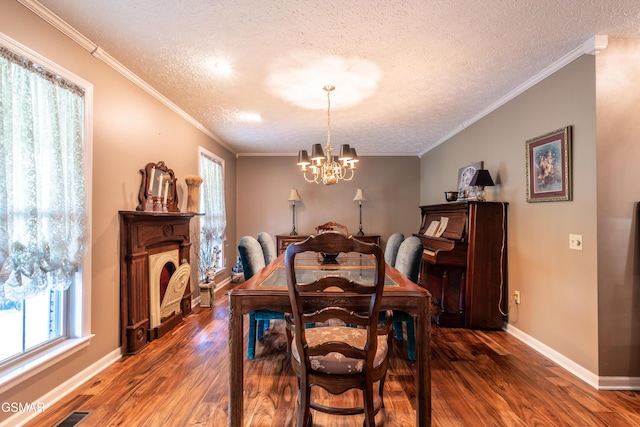 3012 Roaring Creek Way, Sevierville, TN 37862 - dining room featuring wood finished floors, a textured ceiling, a chandelier, crown molding, and a fireplace
