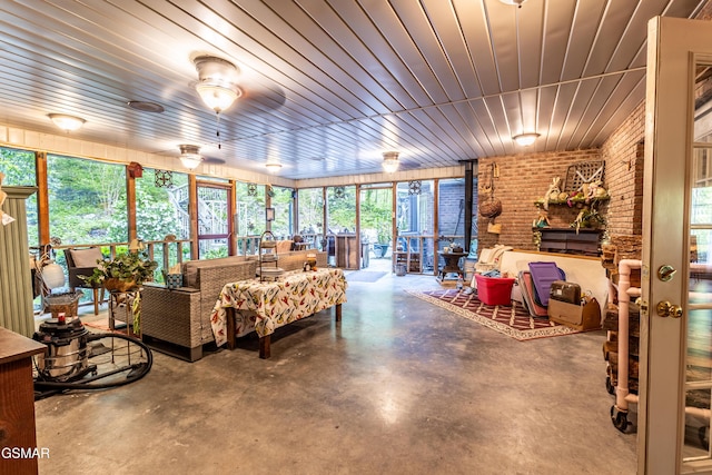 3012 Roaring Creek Way, Sevierville, TN 37862 - sunroom featuring finished concrete floors, brick wall, and healthy amount of natural light