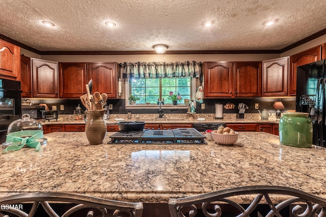 3012 Roaring Creek Way, Sevierville, TN 37862 - kitchen with crown molding, black appliances, light stone countertops, a textured ceiling, and backsplash