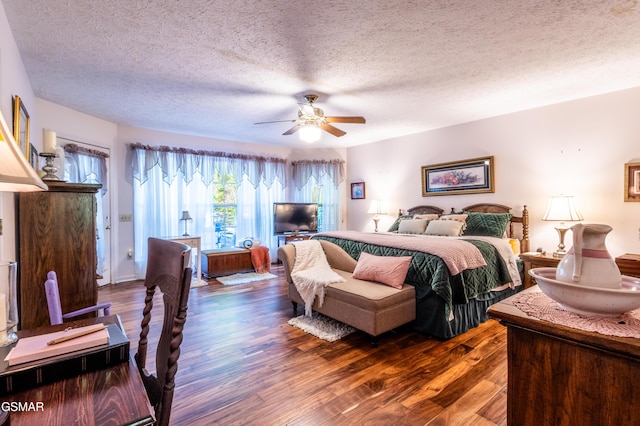 3012 Roaring Creek Way, Sevierville, TN 37862 - bedroom featuring dark wood-style floors, a textured ceiling, and a ceiling fan