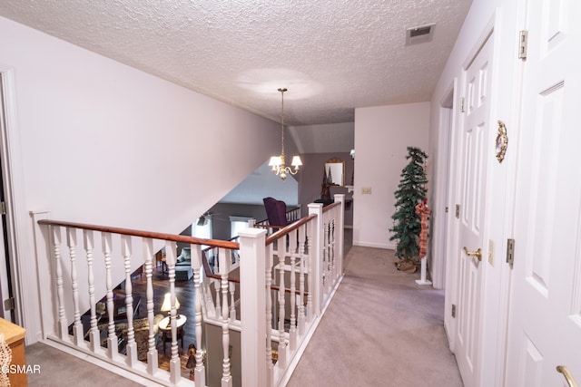 3012 Roaring Creek Way, Sevierville, TN 37862 - corridor featuring an upstairs landing, carpet flooring, a textured ceiling, and a chandelier