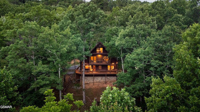 rear view of house featuring a deck