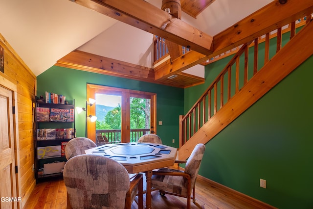 dining space featuring hardwood / wood-style floors and lofted ceiling