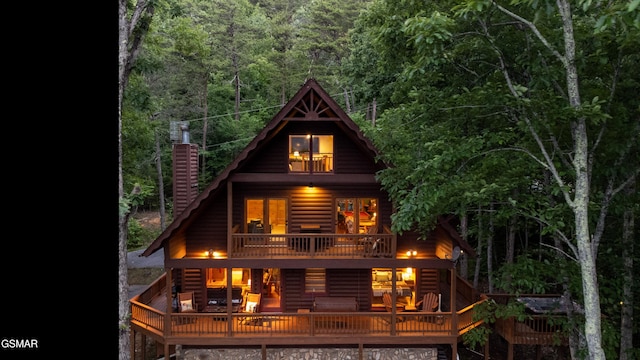 rear view of house featuring a balcony