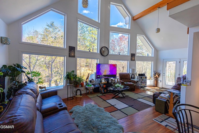 living room with beamed ceiling, hardwood / wood-style floors, and high vaulted ceiling