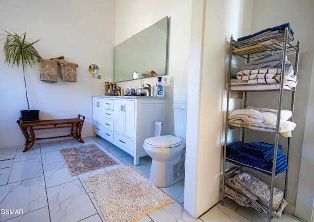 bathroom featuring toilet and vanity