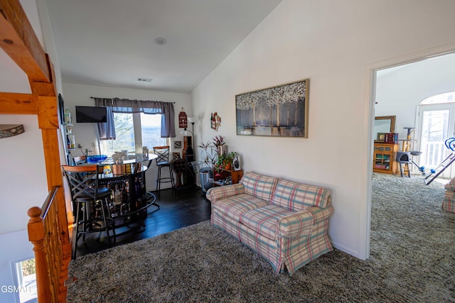 living room featuring dark hardwood / wood-style flooring and lofted ceiling