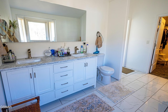 bathroom featuring toilet and vanity