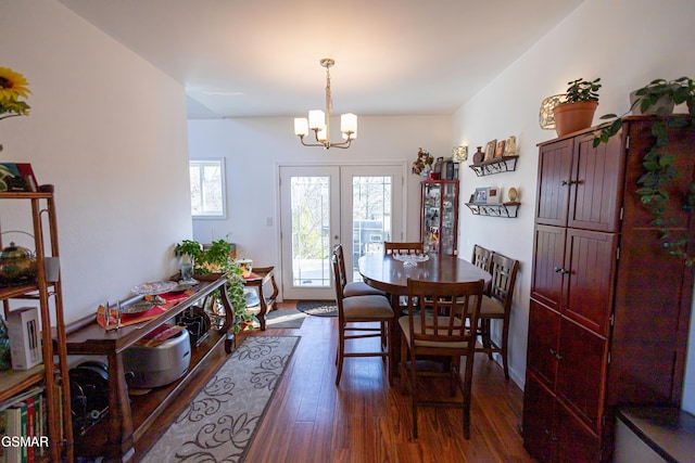 dining room featuring french doors, dark hardwood / wood-style floors, and a notable chandelier